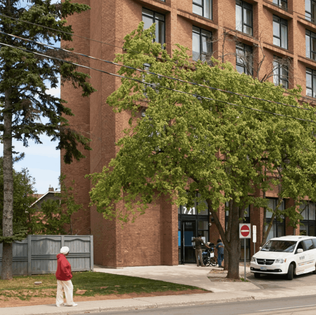 Person walking outside a WoodGreen building in the daytime