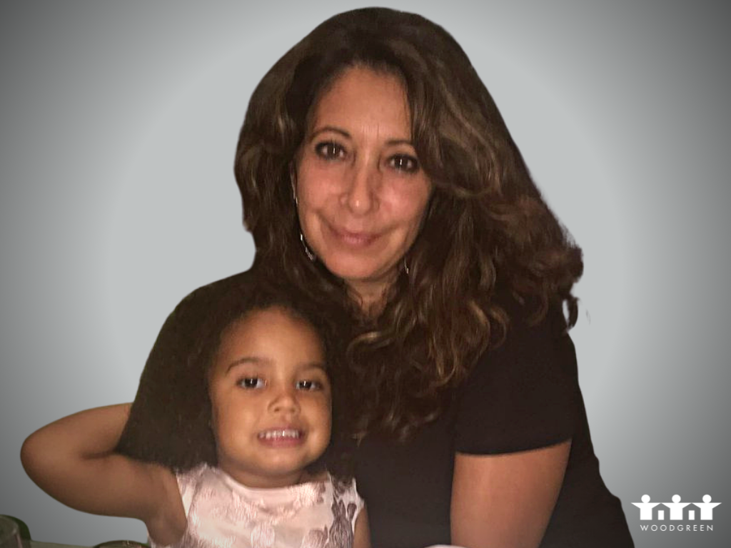 a grandmother and her granddaughter hug at home