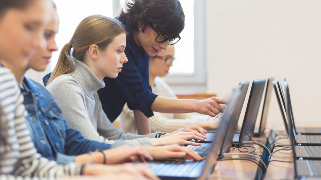 Students complete work on computers.