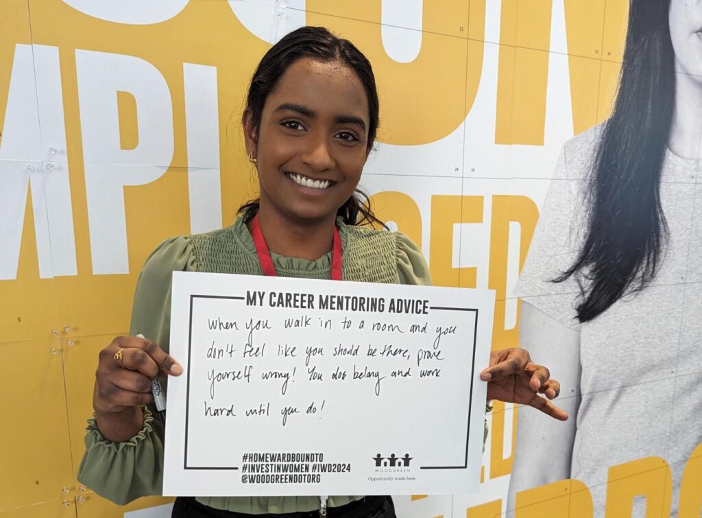 Woman holds up a piece of paper with career mentoring advice at CIBC SQUARE