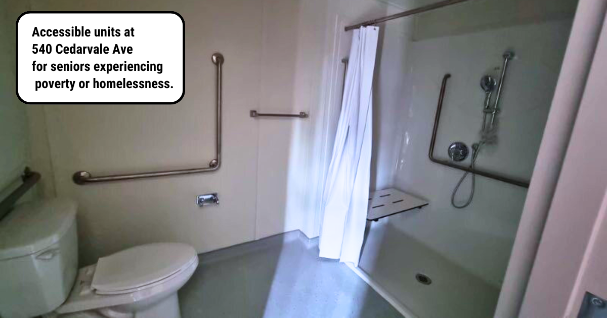 a bathroom designed to be accessible for someone with a disability features a roll-in shower and grab bars throughout